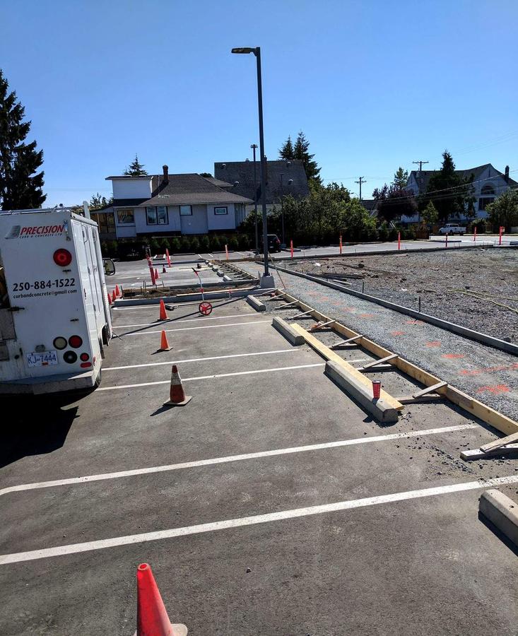 Forming concrete curb and sidewalk across a commercial parking lot in Esquimalt, BC