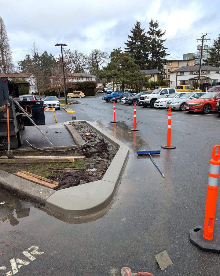 Finished concrete curb with a smooth bullnose end on a parking-lot island in Langford, BC