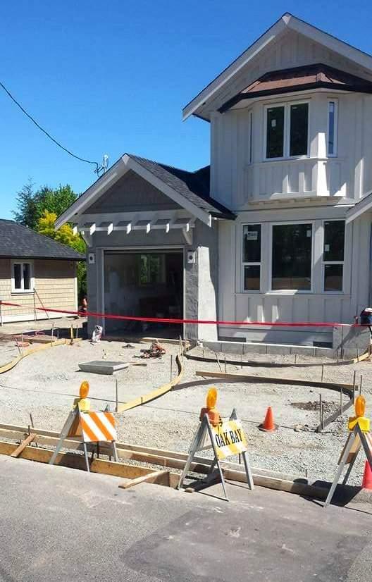 Curved curb and driveway forms set up in front of a new build in Oak Bay, BC