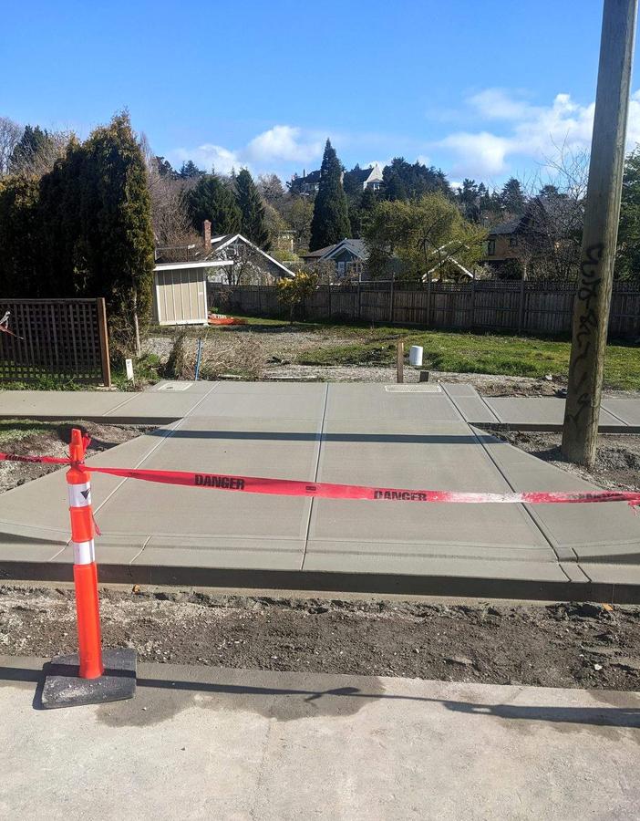 Freshly poured concrete driveway with a letdown to the road in Saanich, BC