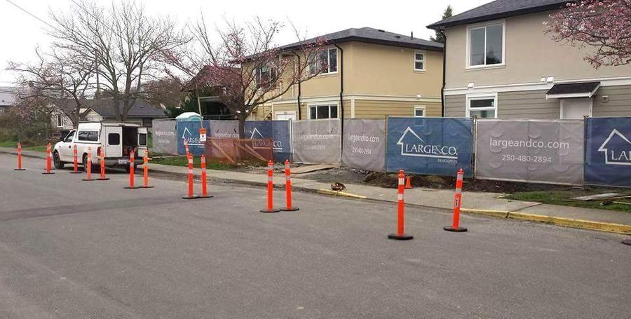 Coned-off road and traffic control set up for new curb and sidewalk work at a development in Victoria, BC