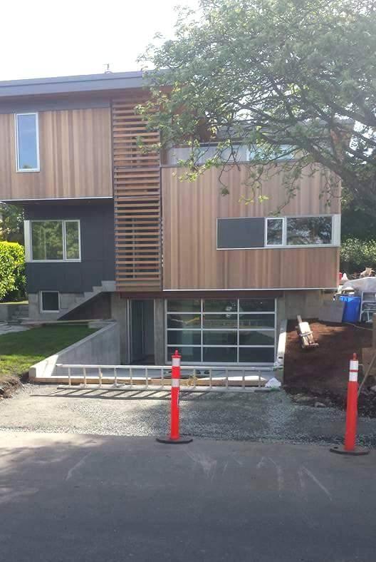 Gravel base and forms set for a new curb and driveway apron at a modern home in Victoria, BC